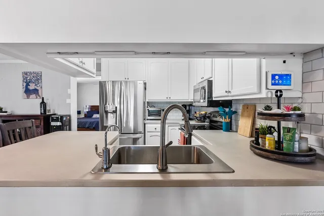 a kitchen with a sink a counter top space and cabinets