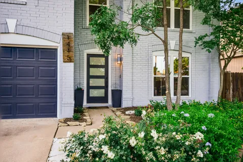 a front view of a house with a garden