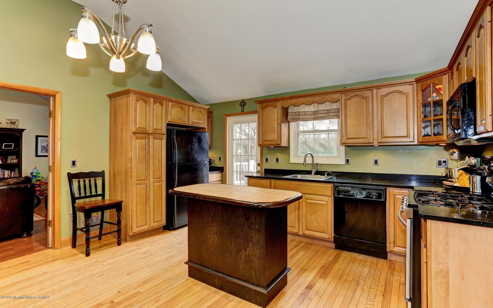40 Drift Road Middletown, NJ 07718 - Photo 13 of 25 a kitchen with stainless steel appliances granite countertop a stove a sink dishwasher and a refrigerator with wooden floor