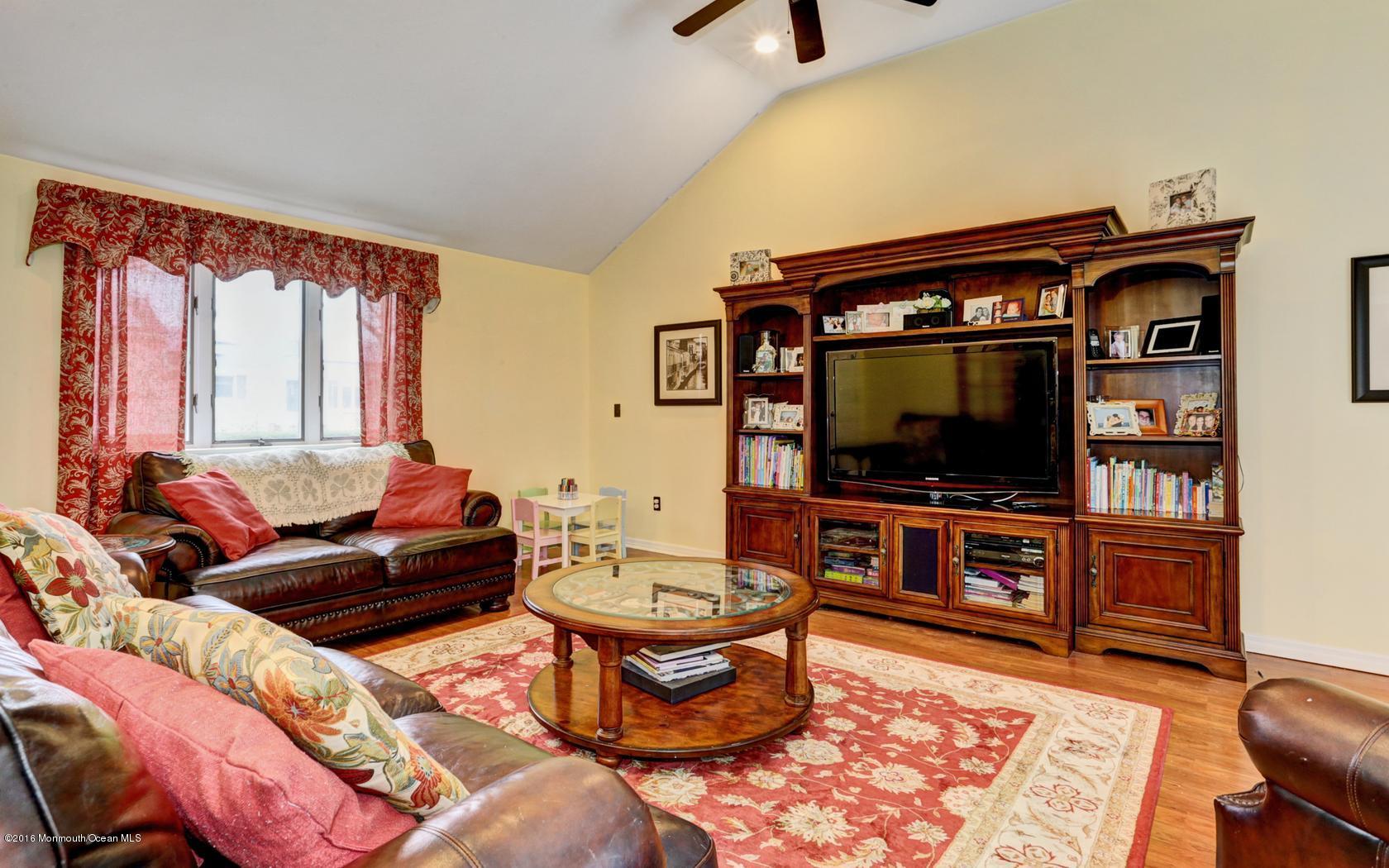 40 Drift Road Middletown, NJ 07718 - Photo 15 of 25 a living room with furniture and a flat screen tv