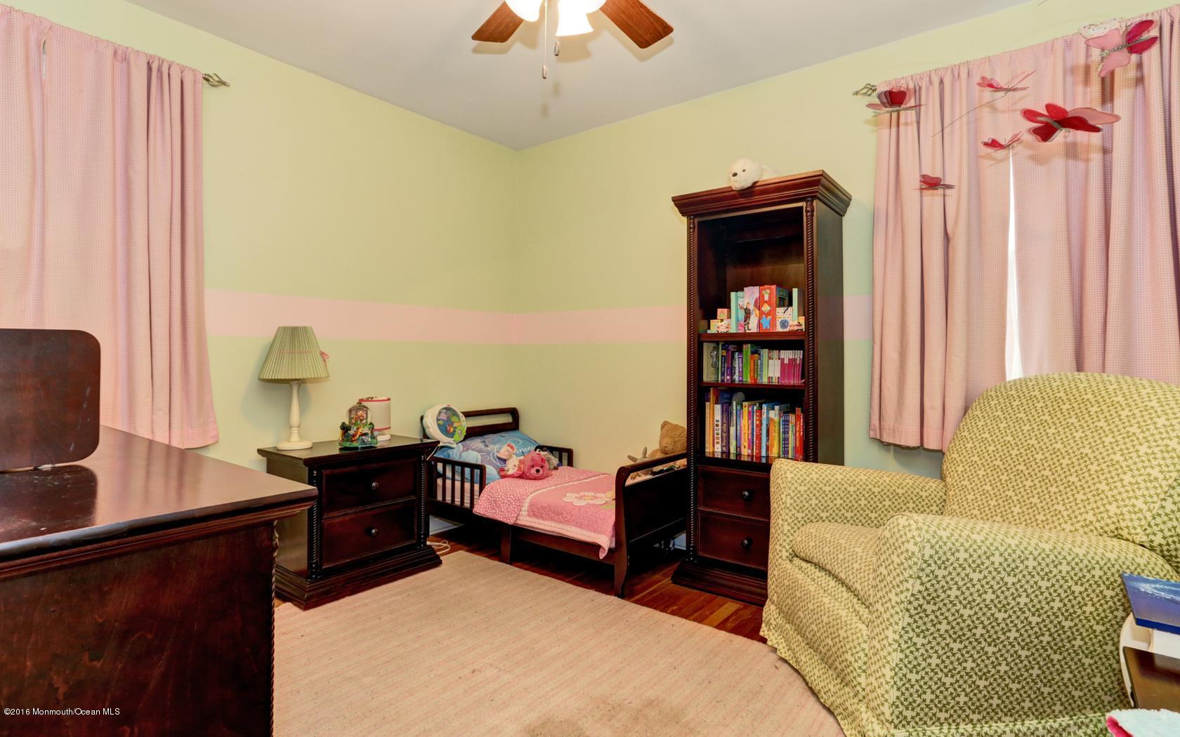 40 Drift Road Middletown, NJ 07718 - Photo 16 of 25 a bedroom with furniture and a book shelf