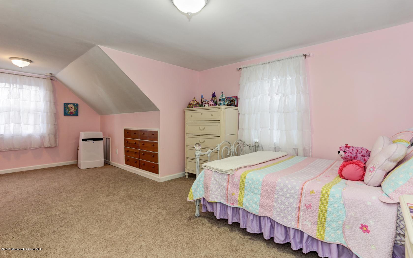 40 Drift Road Middletown, NJ 07718 - Photo 17 of 25 a bedroom with a bed and a fireplace
