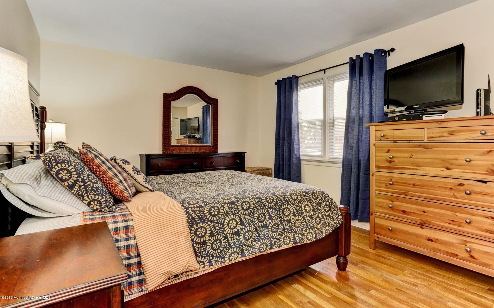 40 Drift Road Middletown, NJ 07718 - Photo 19 of 25 a bedroom with a bed and a flat screen tv