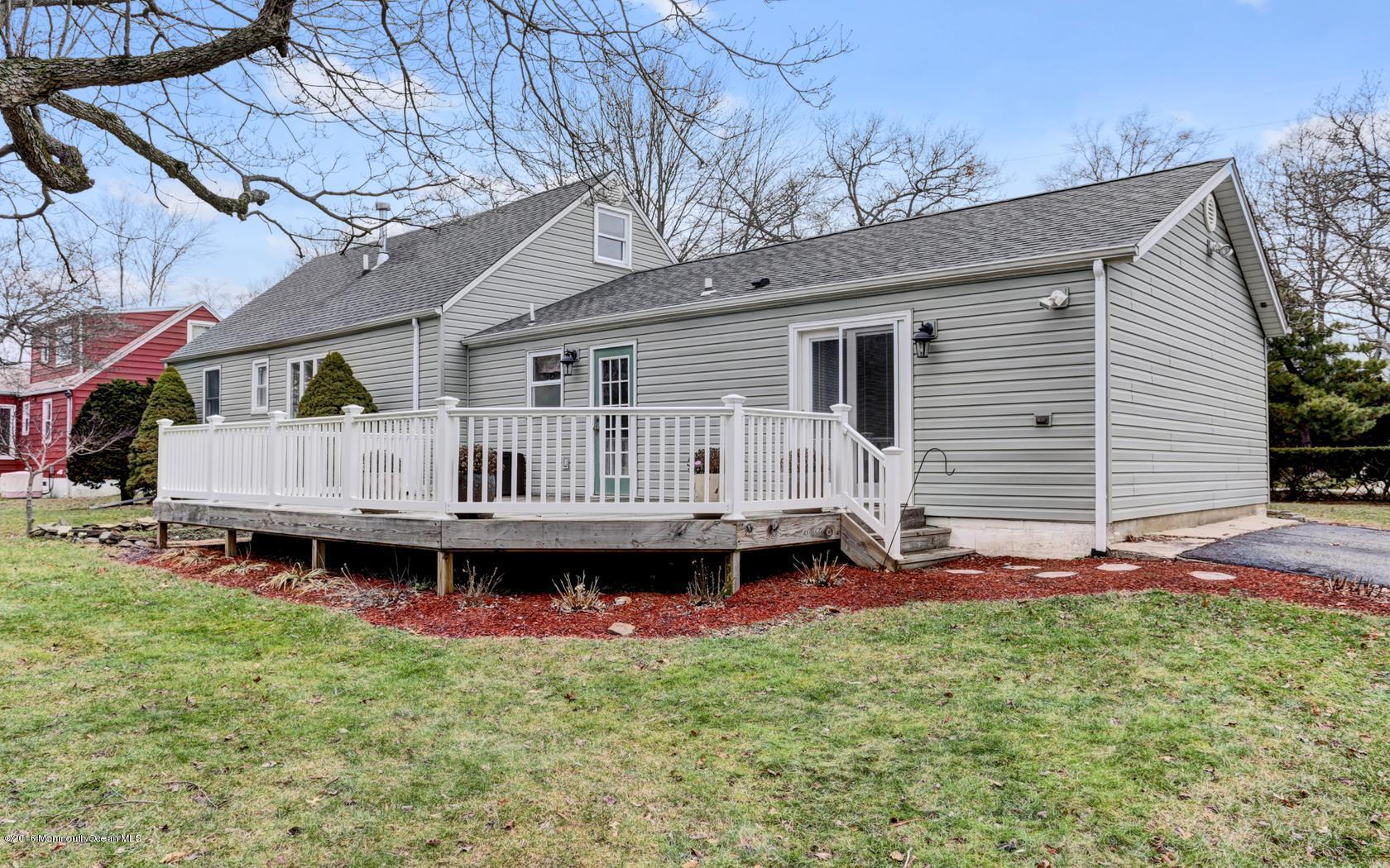 40 Drift Road Middletown, NJ 07718 - Photo 25 of 25 a backyard of a house with wooden deck and barbeque oven