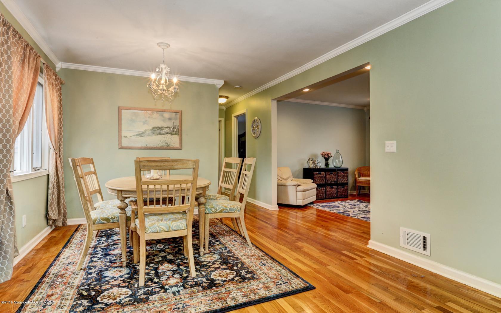 40 Drift Road Middletown, NJ 07718 - Photo 8 of 25 a view of a dining room with furniture a chandelier and wooden floor