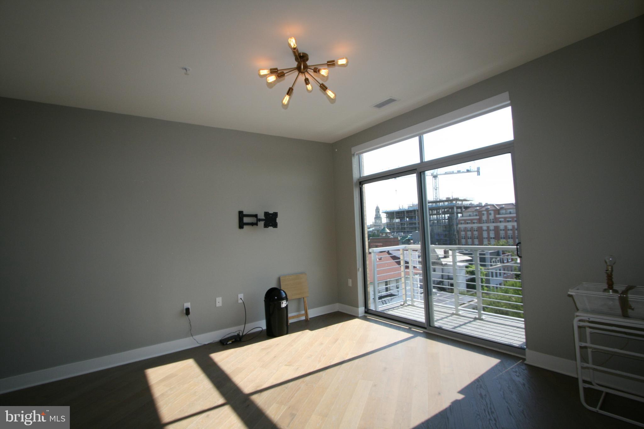 2550 17th Street Northwest, Unit 612 Washington, DC 20009 - Photo 12 of 55 a bedroom with a bed and a large window with outer view