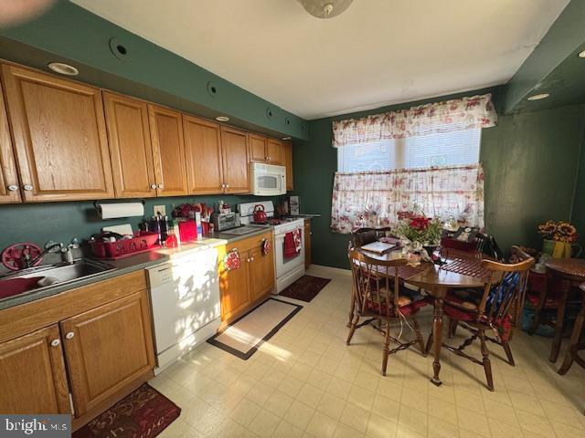 548 Hellerman Street Philadelphia, PA 19111 - Photo 13 of 30 a kitchen with sink cabinets and dining table chair