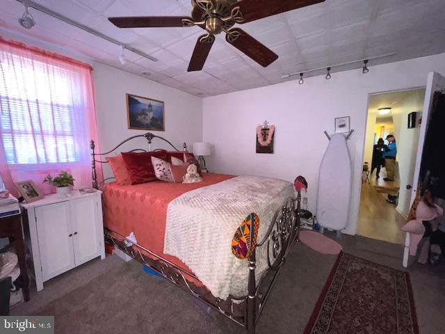 548 Hellerman Street Philadelphia, PA 19111 - Photo 16 of 30 a bedroom with a bed and a chandelier