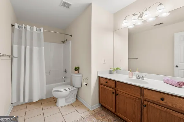 a kitchen with stainless steel appliances kitchen island granite countertop a stove a sink dishwasher a refrigerator and a oven with wooden floor
