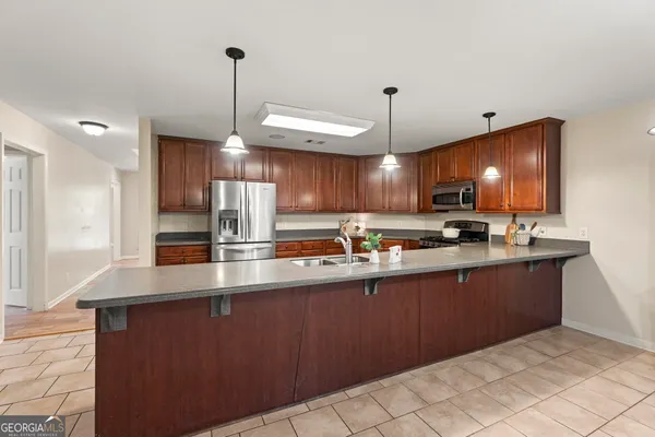 a view of a kitchen with microwave and cabinets