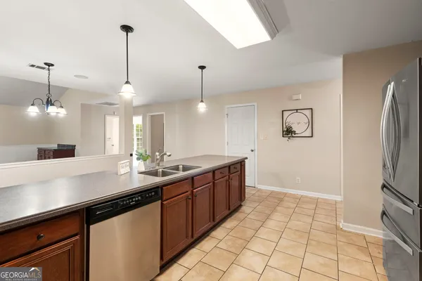 a view of a kitchen with microwave and refrigerator