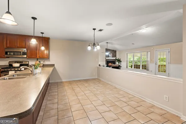 a living room with furniture and a view of kitchen