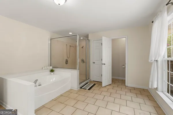 a bathroom with a tub and shower