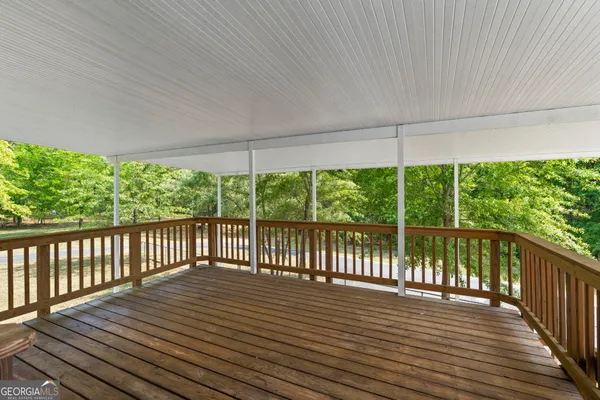 an aerial view of a house with a yard and outdoor seating