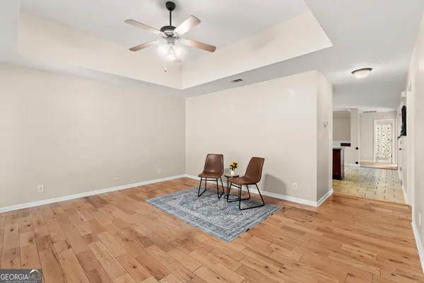 a kitchen with stainless steel appliances granite countertop a sink a stove and a wooden floors