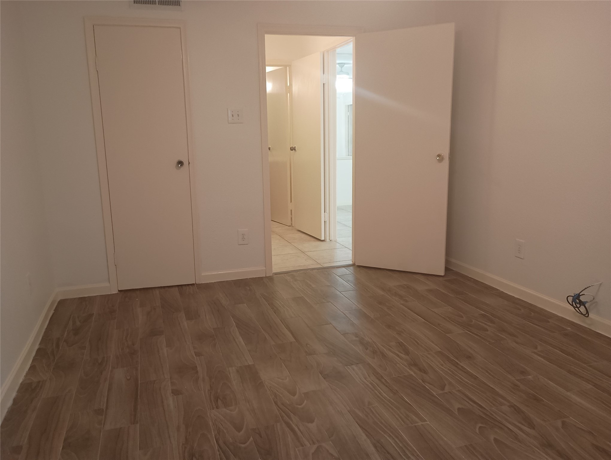 8787 Brae Acres Road, Unit 307 Houston, TX 77074 - Photo 10 of 15 a view of an empty room with wooden floor