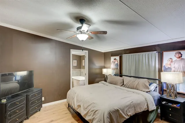 a bedroom with a bed and a lamp