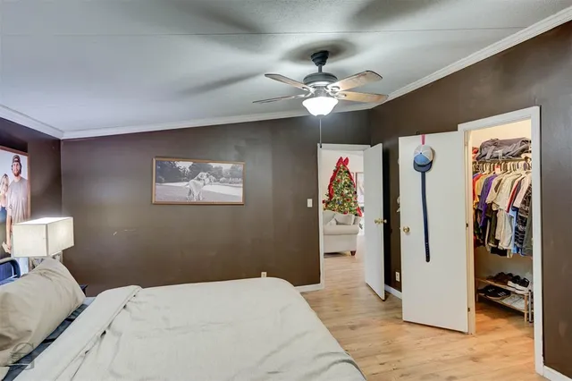 a bedroom with a large bed and a chandelier