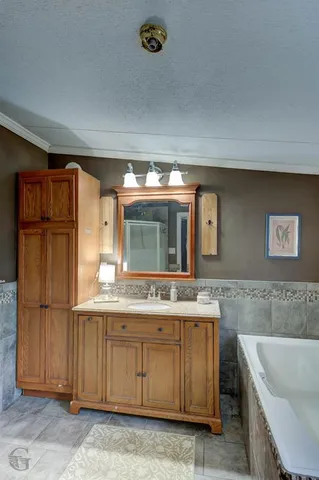 a bathroom with a sink a mirror and a bathtub