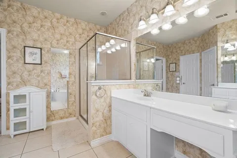 a spacious bathroom with a sink a mirror and a shower