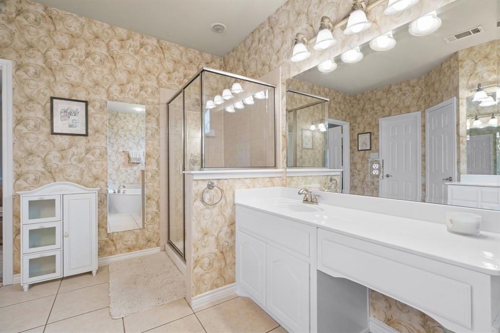 2703 Pottery Trail Corinth, TX 76210 - Photo 19 of 40 a spacious bathroom with a sink a mirror and a shower
