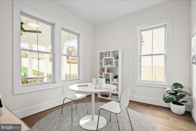 a dining room with furniture window and wooden floor