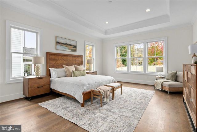 a spacious bedroom with a bed and glass window