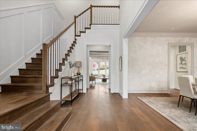 a view of staircase with white walls and furniture