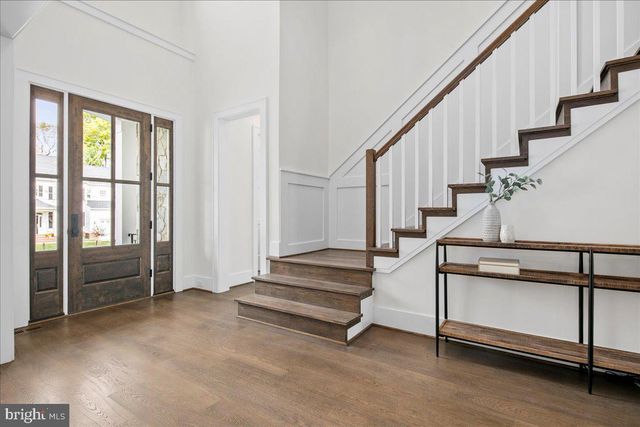 a view of entryway with wooden floor and stairs