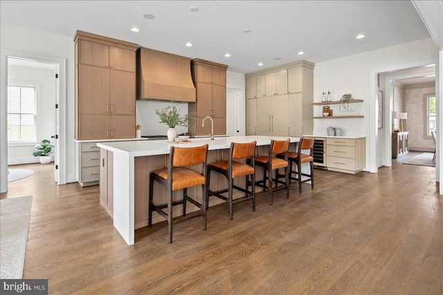 a large kitchen with a table and chairs