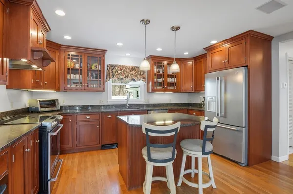 a kitchen with a refrigerator and a sink