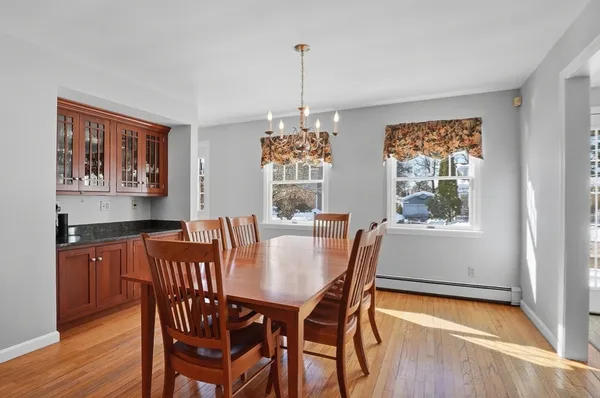 a view of a dining room with furniture window and wooden floor