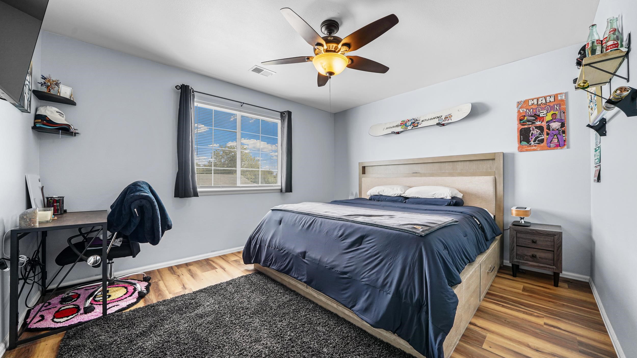 1755 Christopher Way Grand Junction, CO 81503 - Photo 15 of 30 a bedroom with a bed and a chandelier