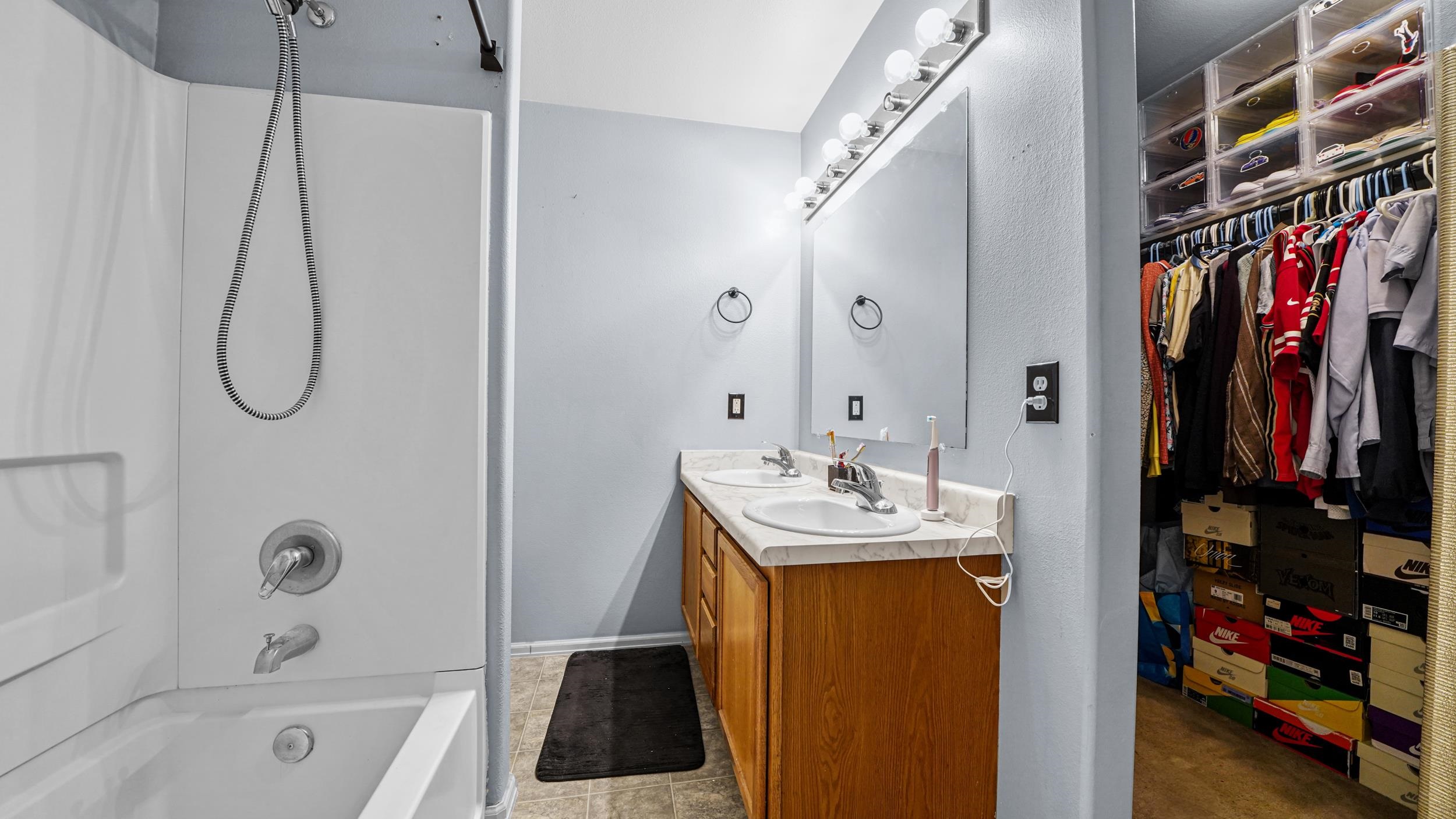 1755 Christopher Way Grand Junction, CO 81503 - Photo 17 of 30 a bathroom with a bath tub a sink and a shower