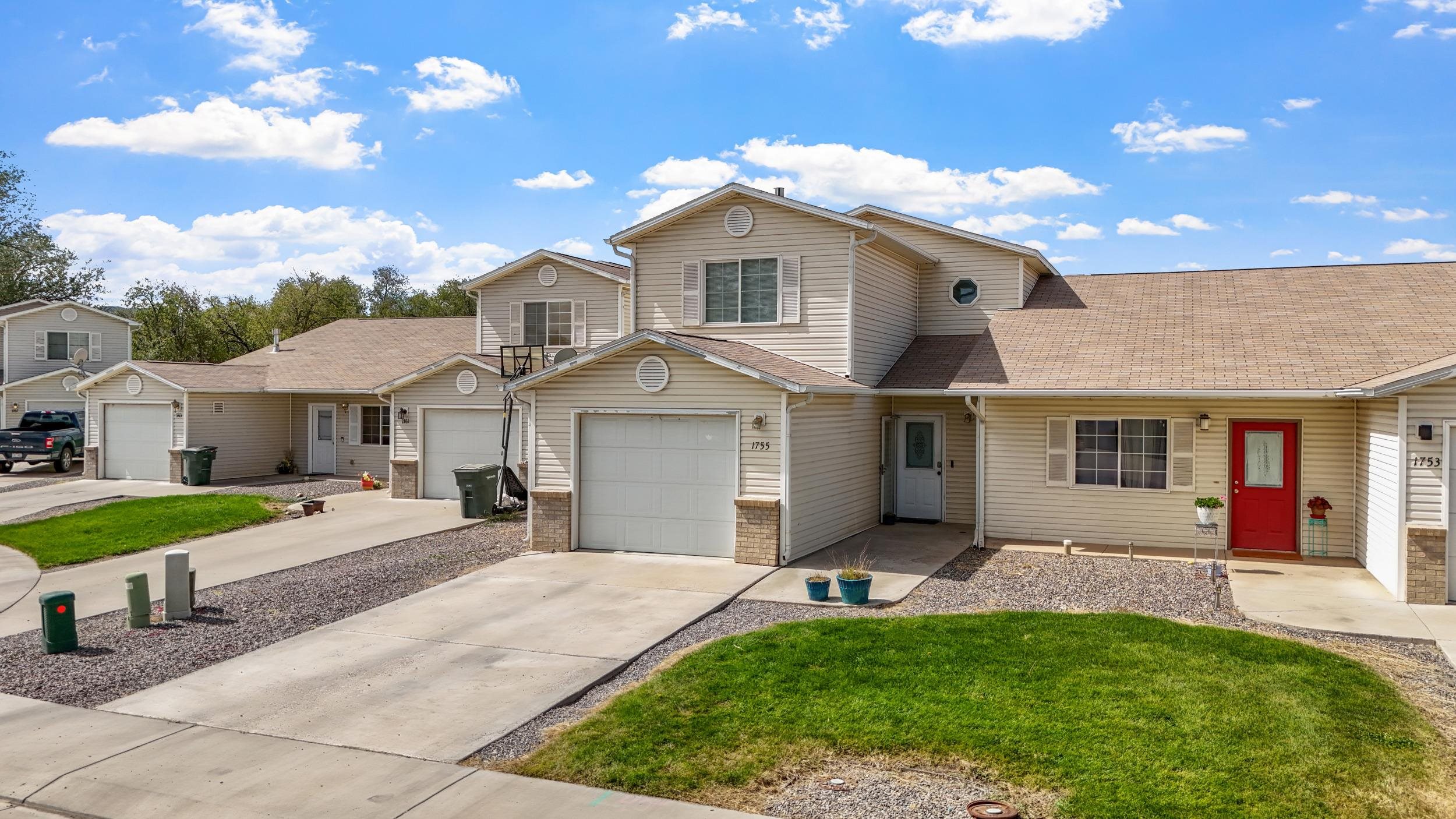 1755 Christopher Way Grand Junction, CO 81503 - Photo 24 of 30 a front view of a house with a yard and porch