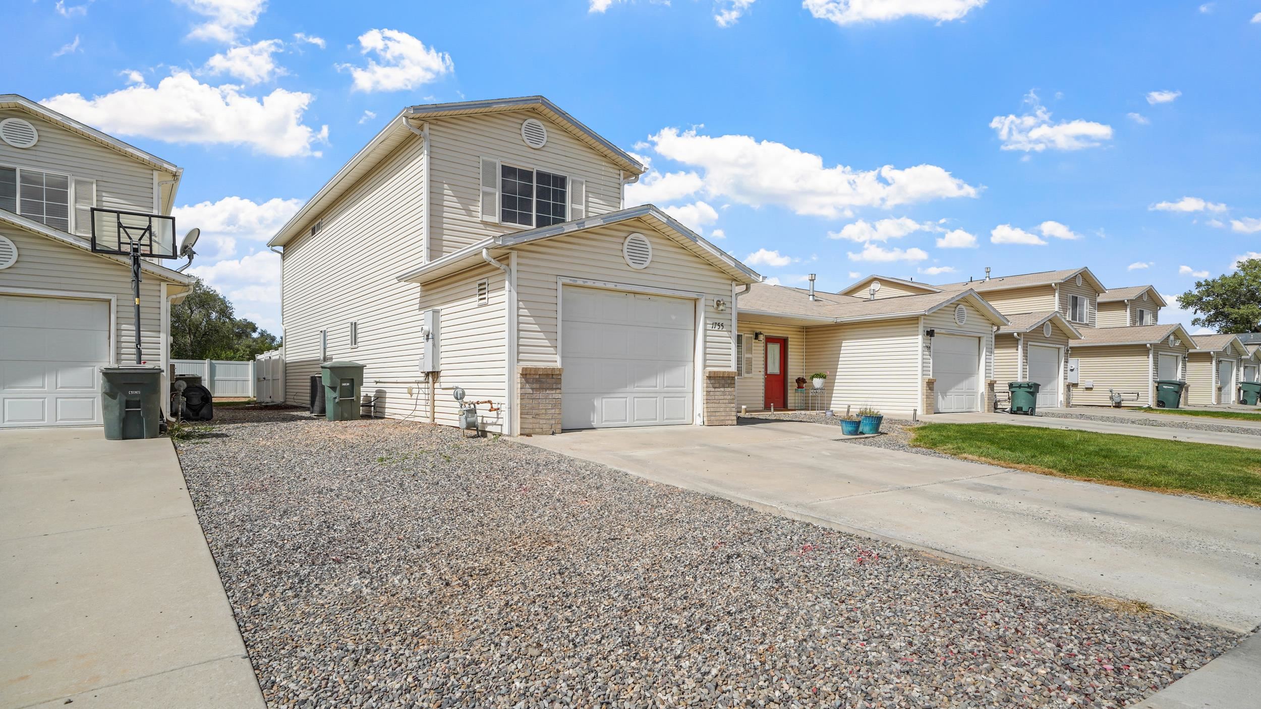 1755 Christopher Way Grand Junction, CO 81503 - Photo 3 of 30 a front view of a house with a yard and garage