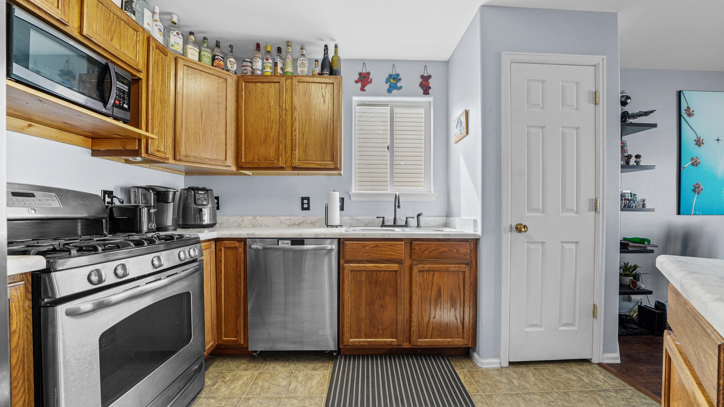 1755 Christopher Way Grand Junction, CO 81503 - Photo 9 of 30 a kitchen with stainless steel appliances granite countertop a stove and a refrigerator