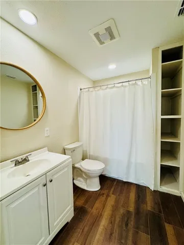 a bathroom with a sink a toilet and a mirror