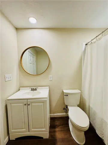 a bathroom with a toilet a sink and a mirror