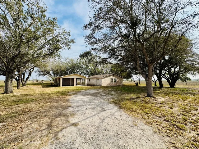 a big yard with large trees