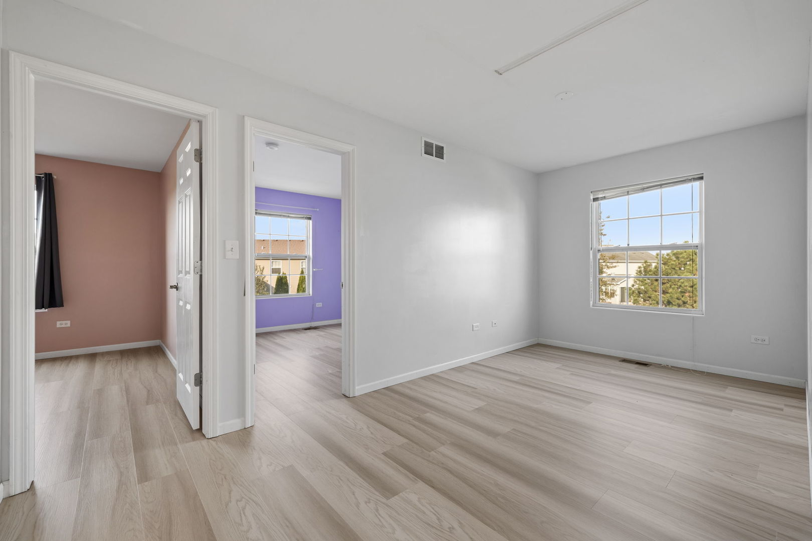 526 Lily Court Minooka, IL 60447 - Photo 11 of 26 a view of an empty room with wooden floor and a window