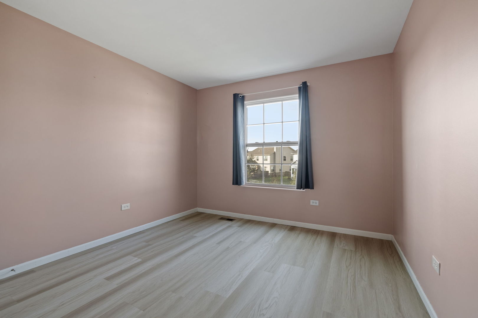 526 Lily Court Minooka, IL 60447 - Photo 12 of 26 wooden floor in an empty room with a window