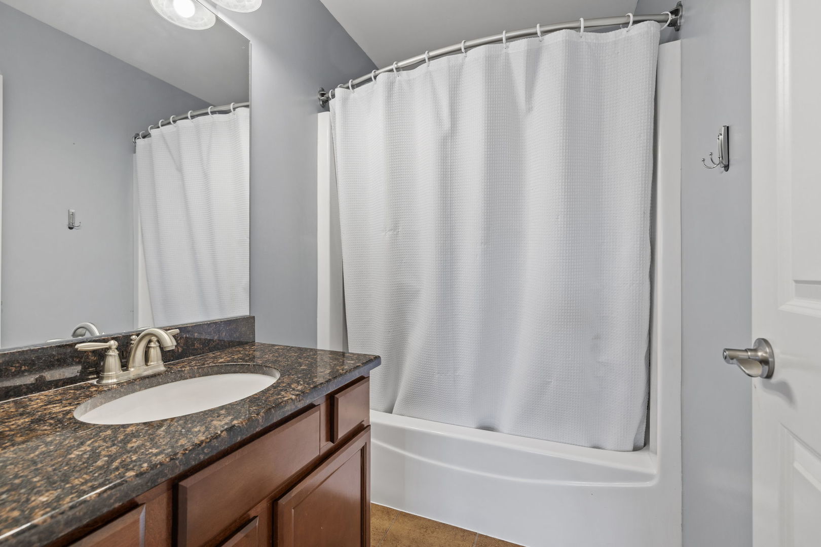 526 Lily Court Minooka, IL 60447 - Photo 14 of 26 a bathroom with a granite countertop sink and a mirror