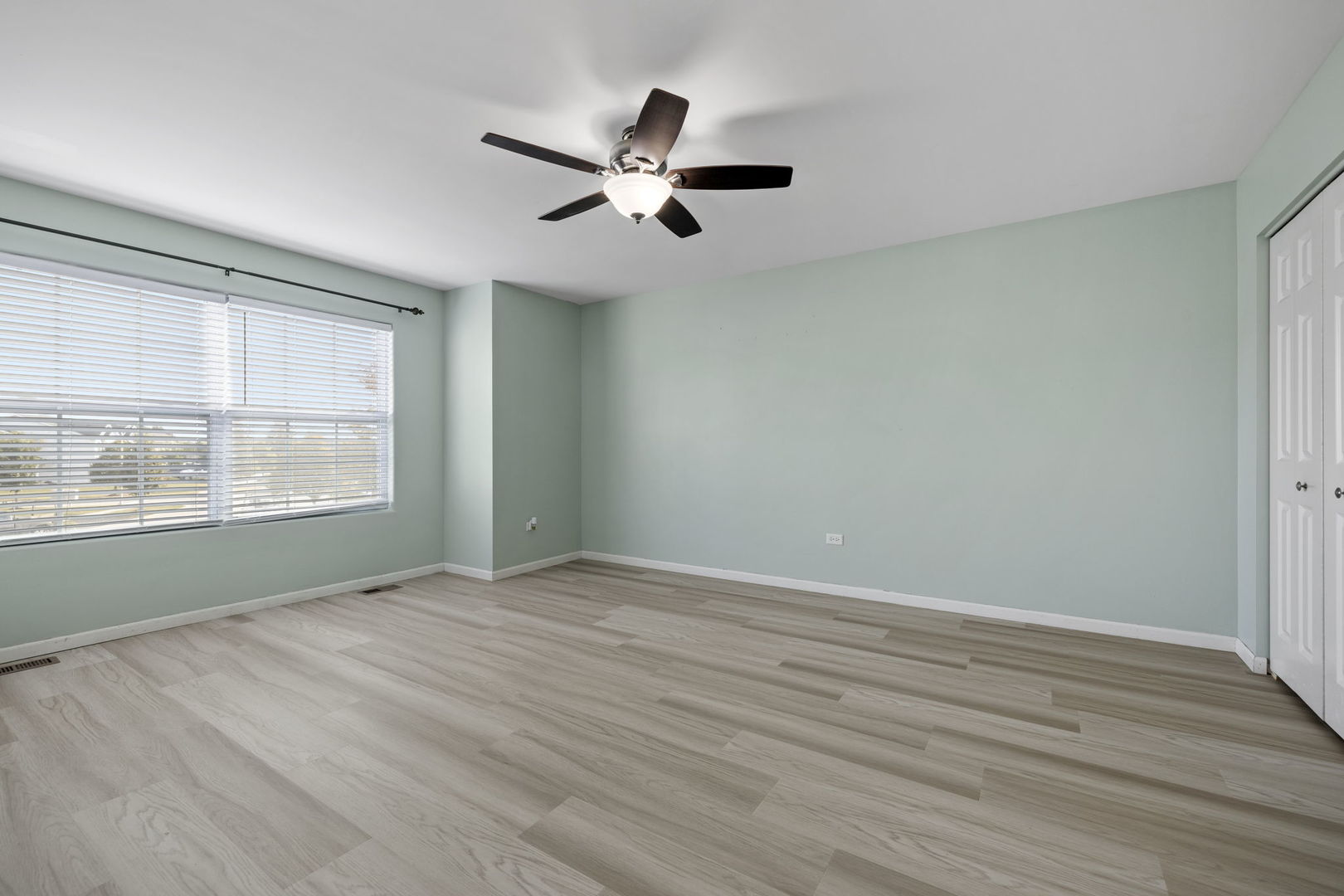 526 Lily Court Minooka, IL 60447 - Photo 16 of 26 a view of an empty room with wooden floor and a window