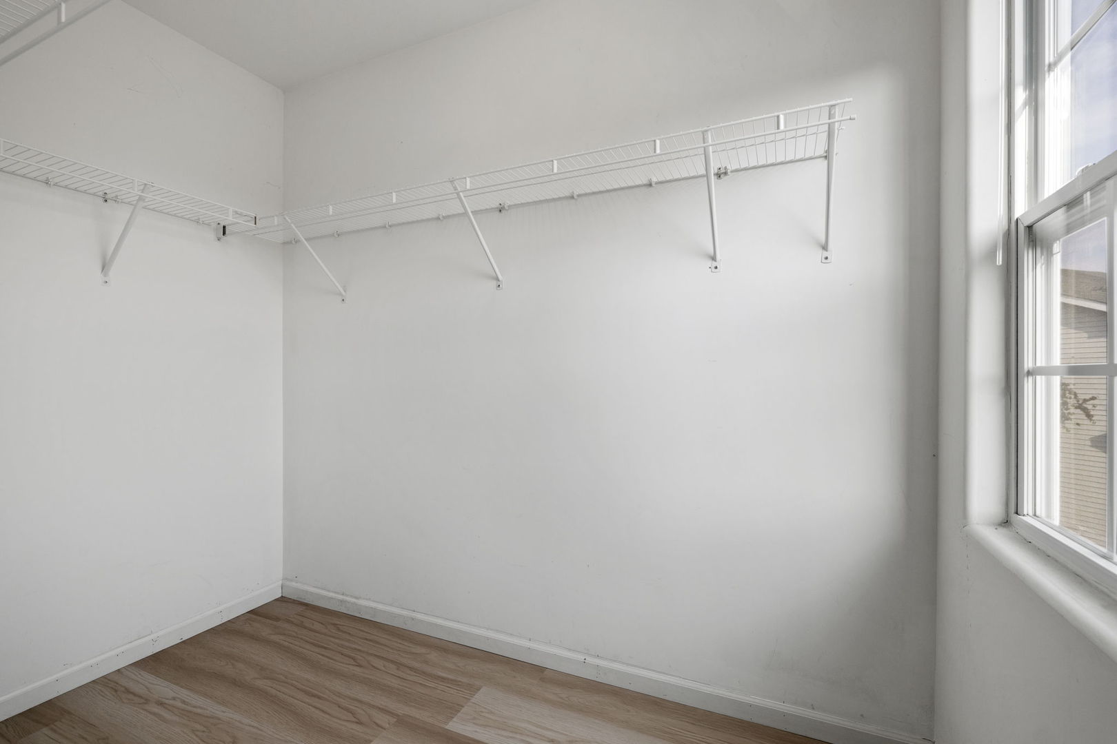 526 Lily Court Minooka, IL 60447 - Photo 17 of 26 a view of a room with wooden floor and fan