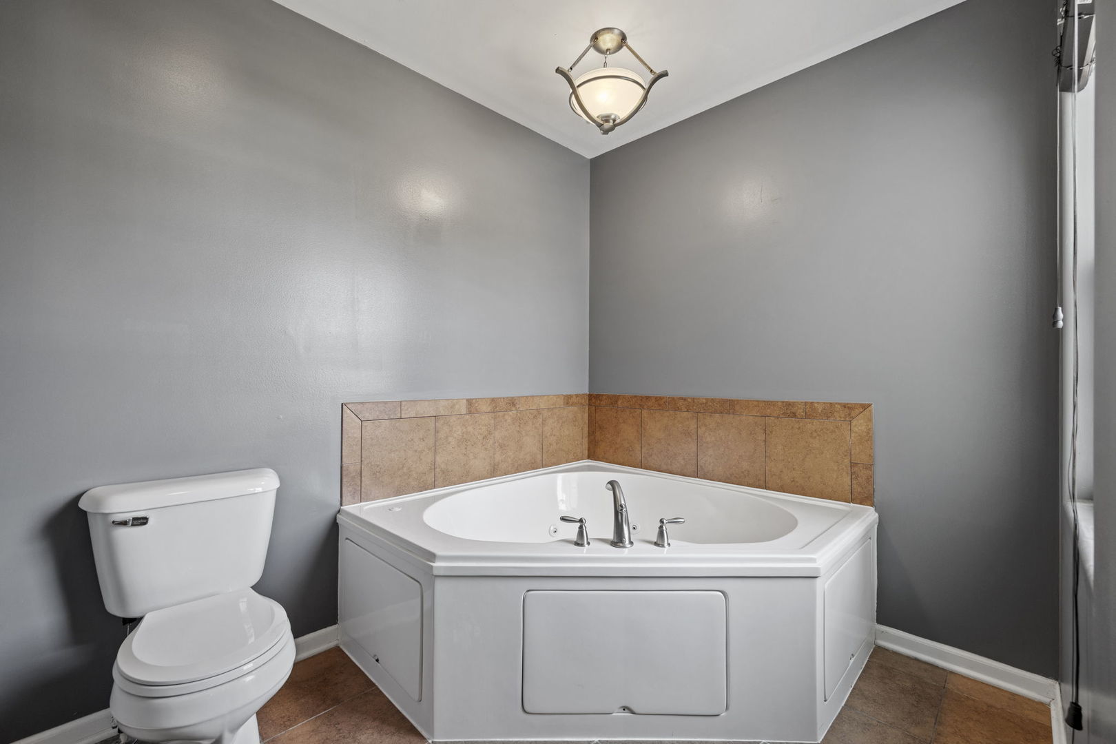 526 Lily Court Minooka, IL 60447 - Photo 19 of 26 a white bath tub sitting next to a toilet