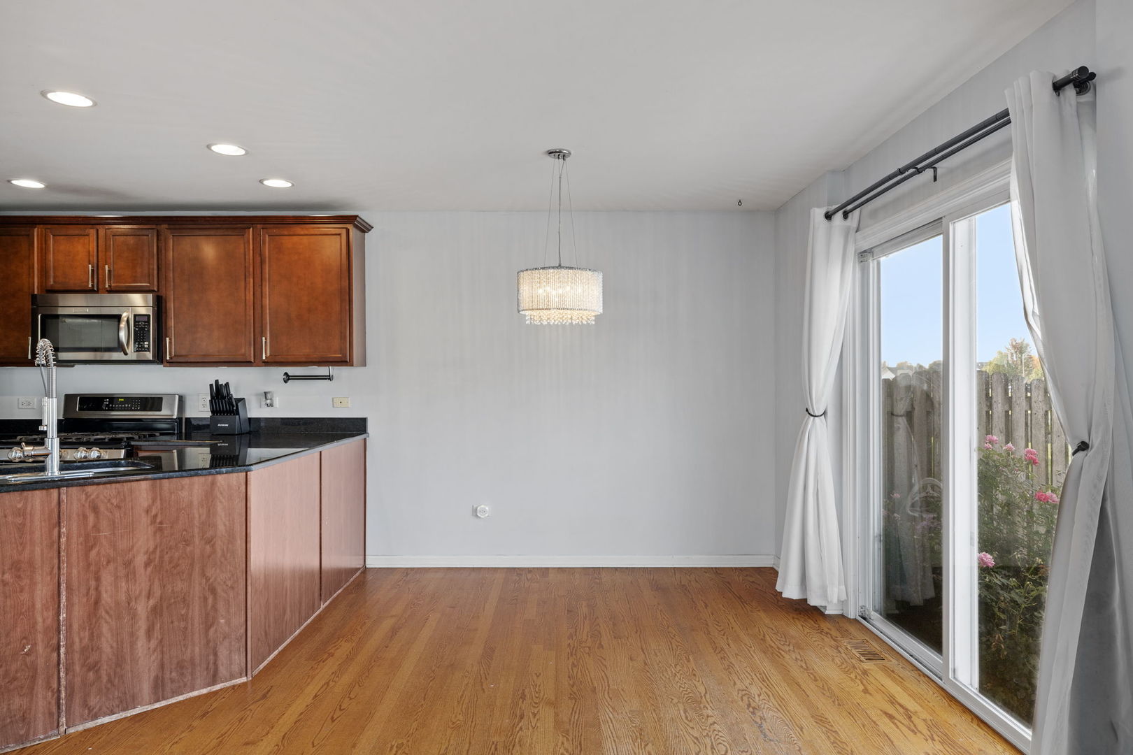 526 Lily Court Minooka, IL 60447 - Photo 5 of 26 a kitchen with stainless steel appliances granite countertop a refrigerator a sink a stove a microwave oven with cabinets and wooden floor