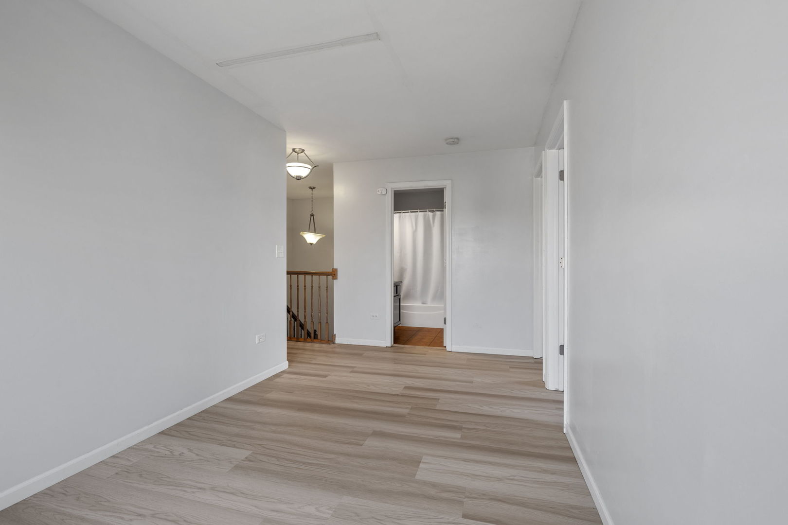 526 Lily Court Minooka, IL 60447 - Photo 10 of 26 a view of a hallway with wooden floor