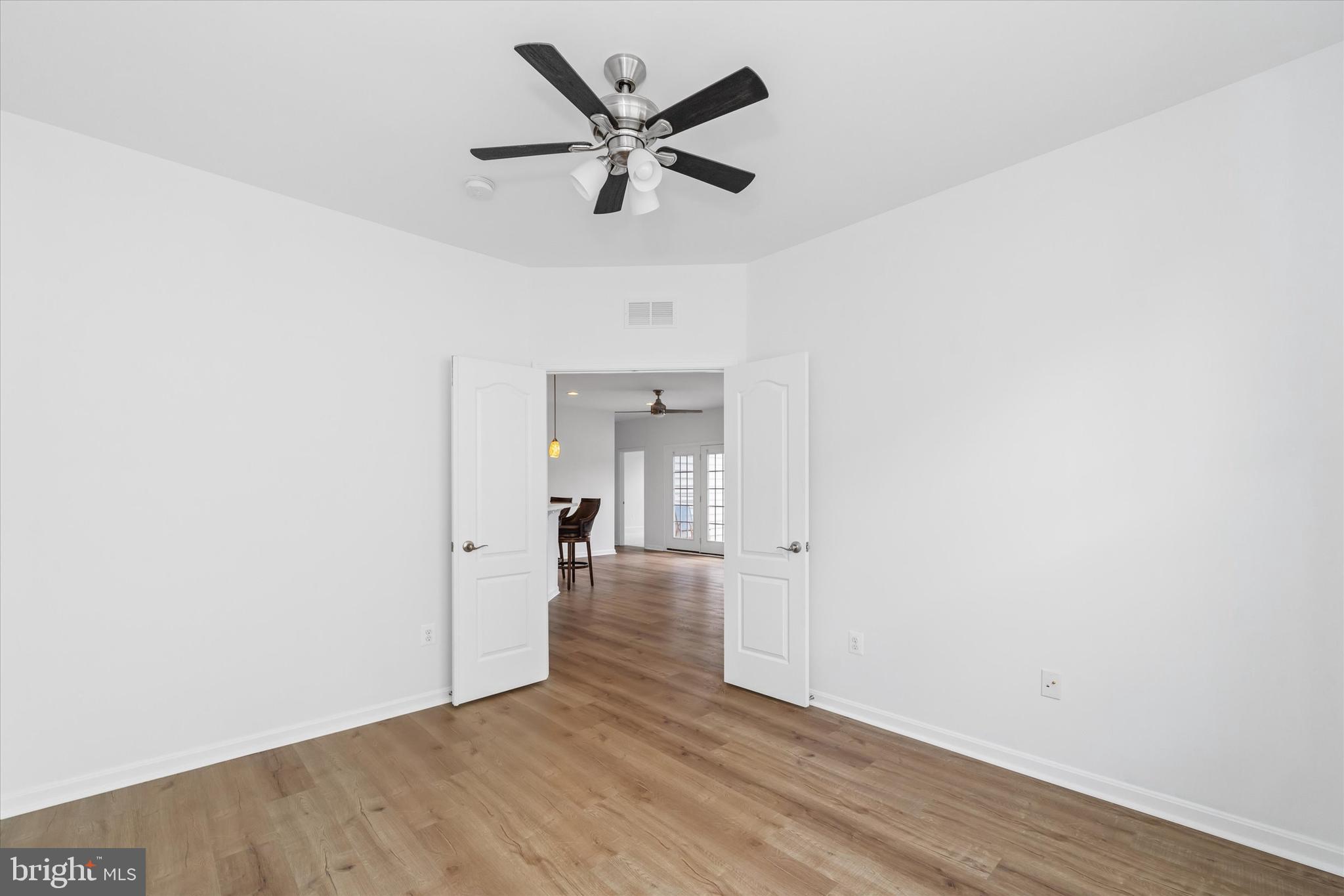 424 Winterberry Drive Middletown, DE 19709 - Photo 20 of 43 an empty room with wooden floor and a ceiling fan