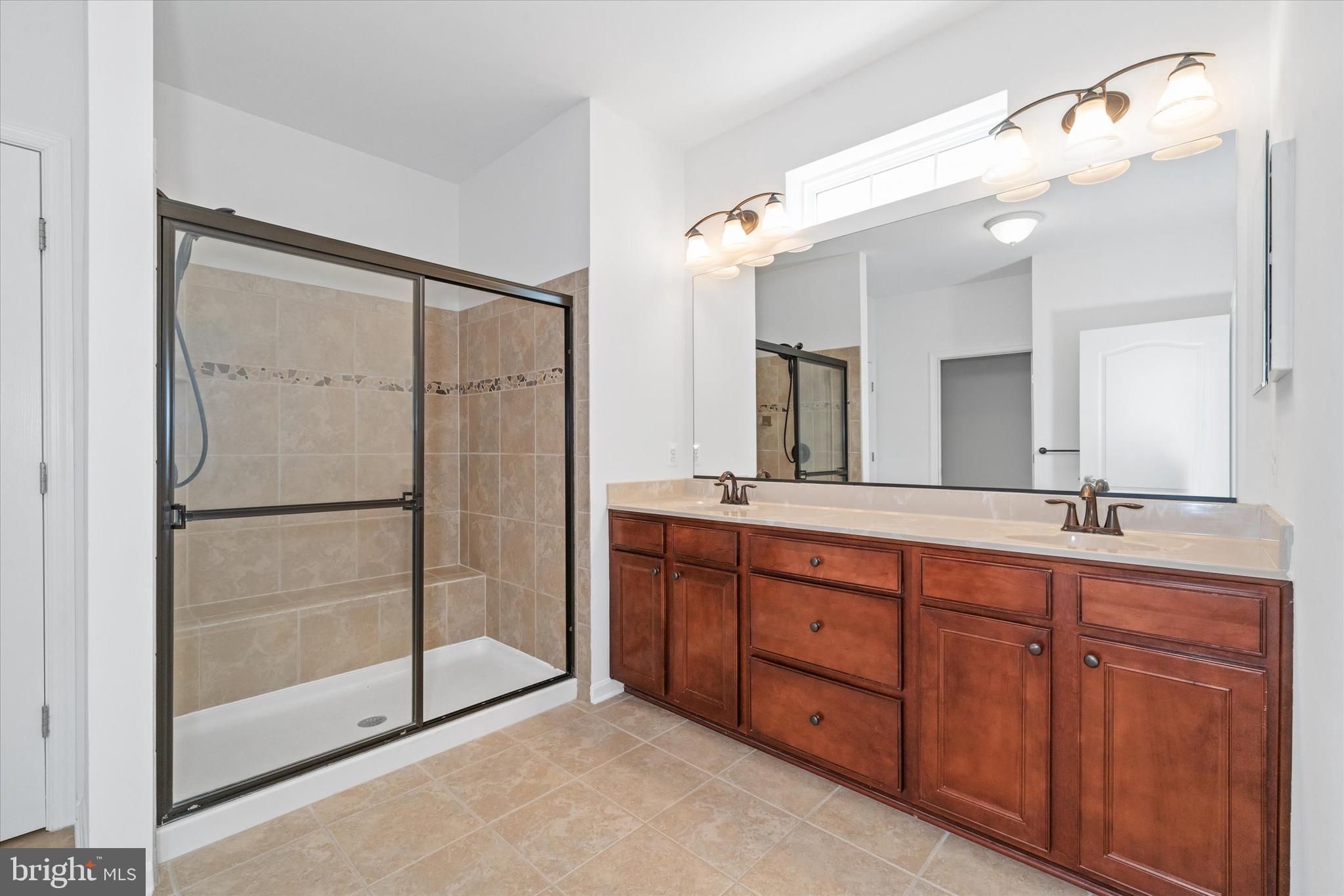 424 Winterberry Drive Middletown, DE 19709 - Photo 24 of 43 a spacious bathroom with a double vanity sink mirror and double
